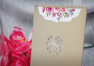 Wedding invitation with monogram cutout sleeve